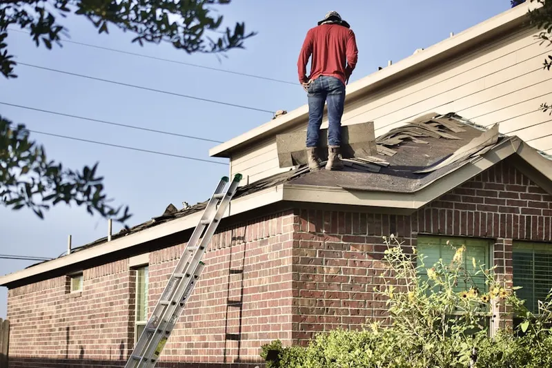 Professional roofer working on a residential roof in Adams Run